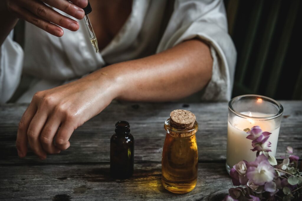 An image of someone applying essential oils, depicting holistic alcohol treatment