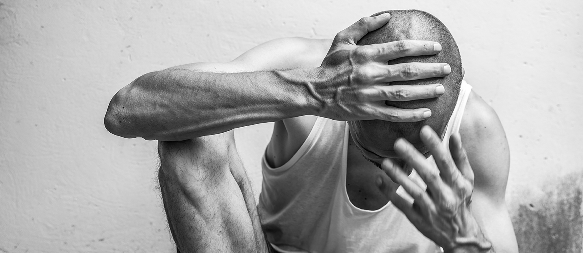 man looking down with his head in his hands