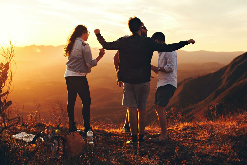 A group of people celebrate on a hillside at sunset to represent drug and alcohol rehab in southern California at Gratitude Lodge.