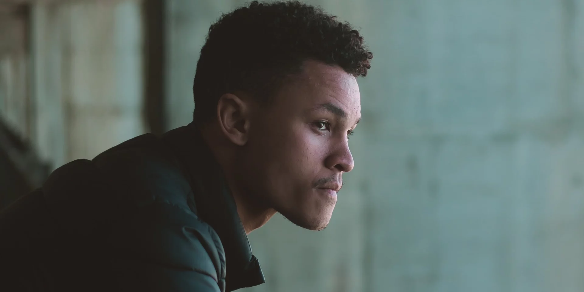 A man looks away representing Polysubstance abuse signs and symptoms.