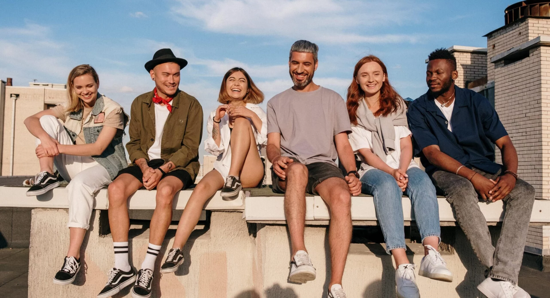 A group of people sit together on the beach to represent treatment for drug and alcohol addiction in Southern California at Gratitude Lodge.
