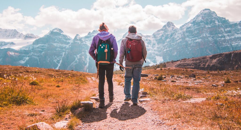 Two people are hiking representing hiking and mental health benefits. 