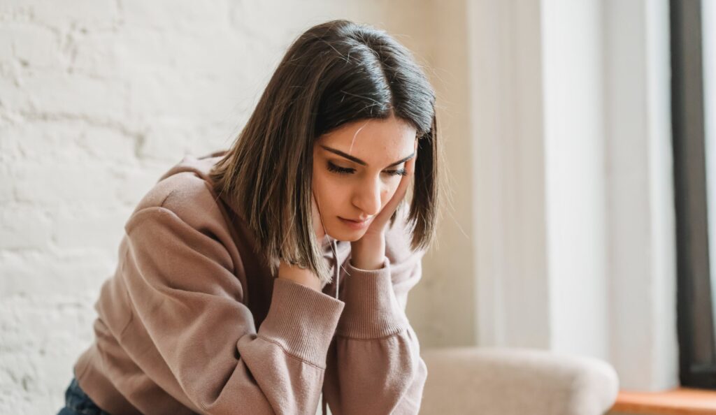 woman looking down representing suicide and substance abuse