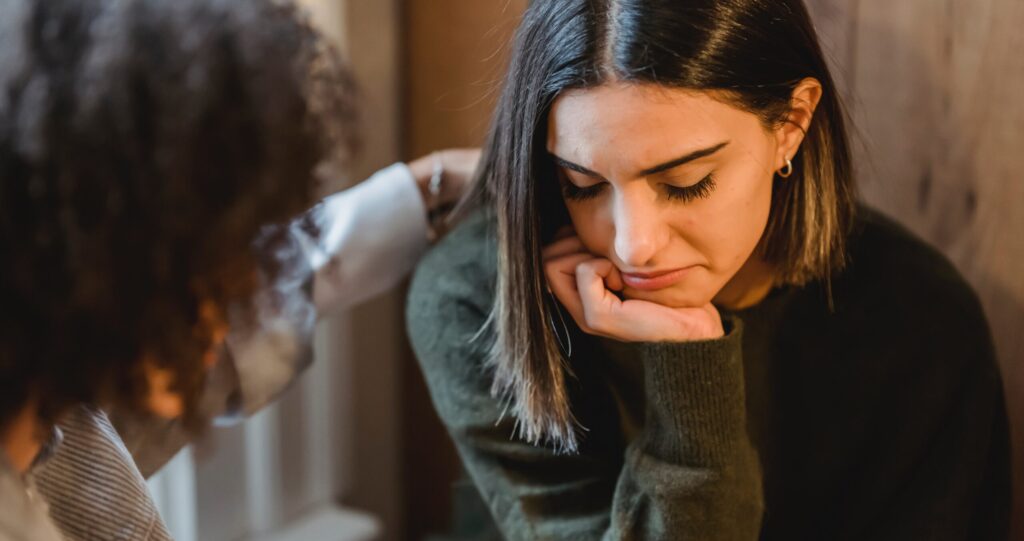 woman being consoled representing what is drug taper