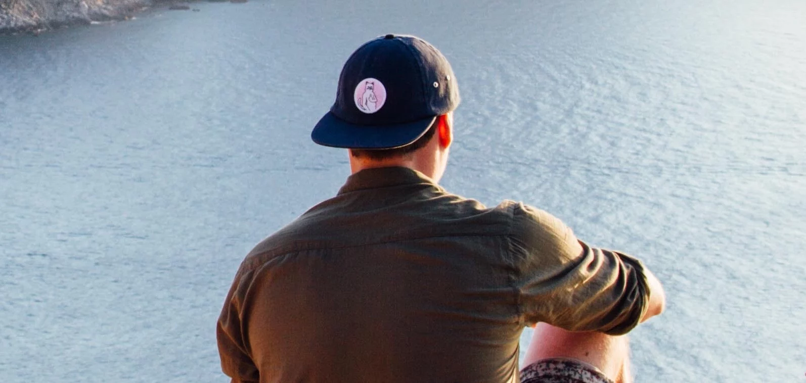 A man looks out at mountains to represent what happens if you drink hand sanitizer