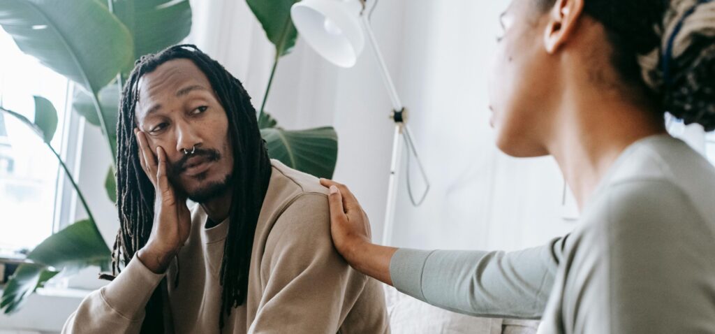 woman comforting man representing How to get help for drug addiction