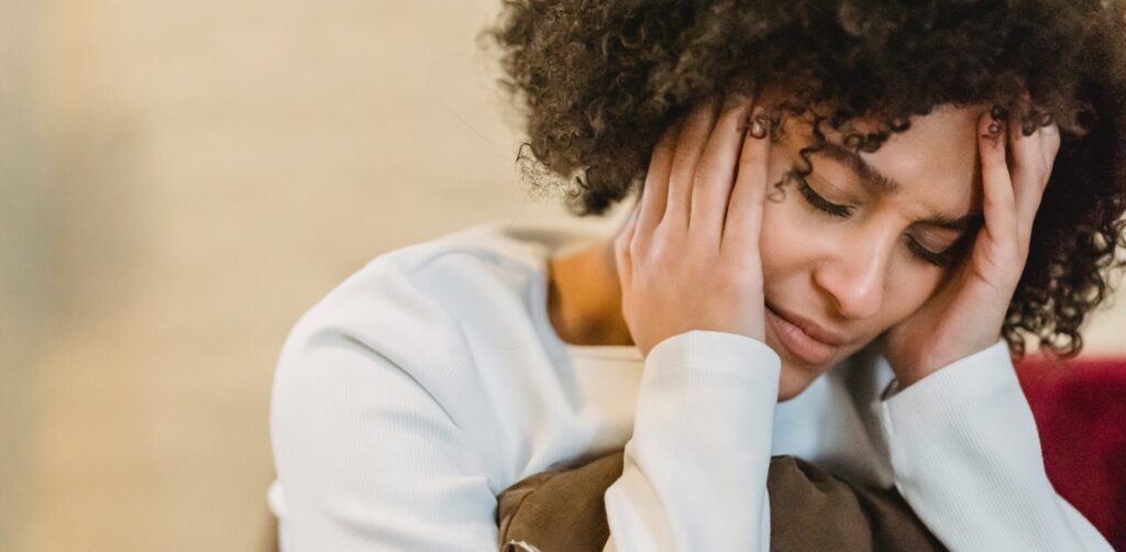 woman with hands on head representing side effects of prozac