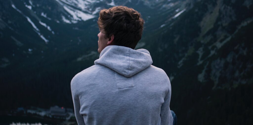 A man in a deep looking out at scenery representing symptoms of freebasing cocaine