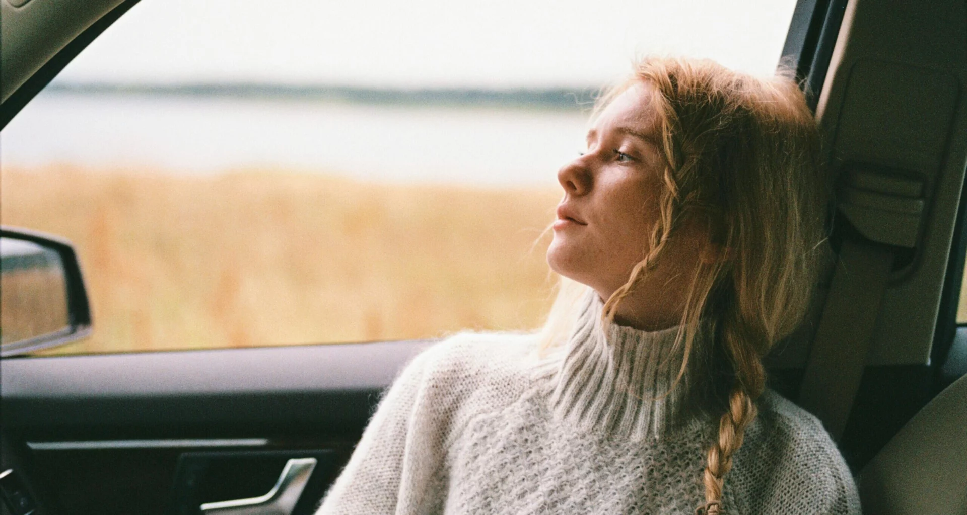 A woman in the car looking troubled, representing vicodin abuse