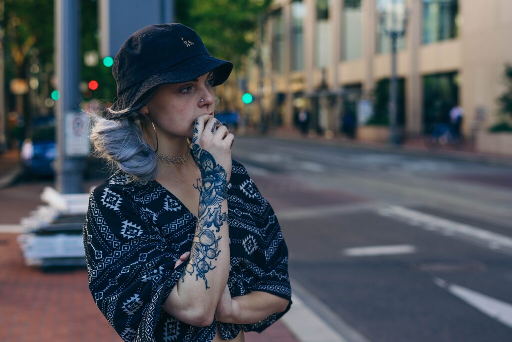 A woman stands on the sidewalk wondering if it is ok to drink alcohol while taking prednisone