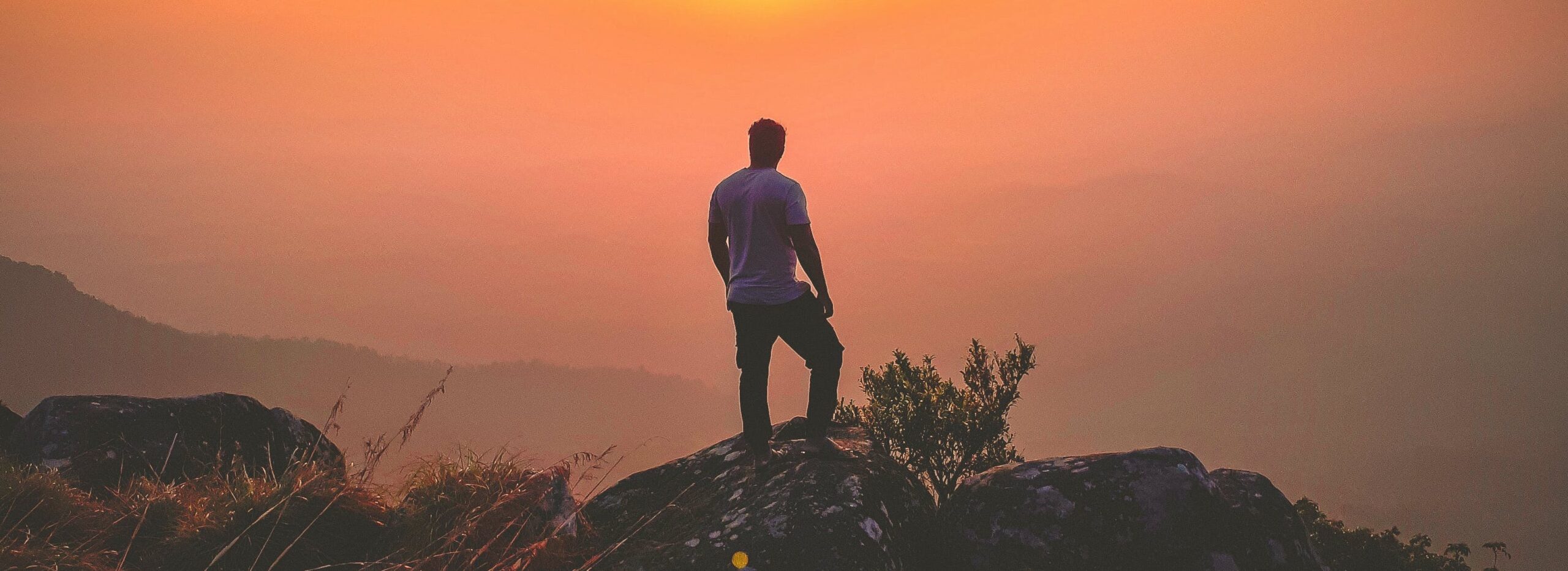 man standing on hill at sunrise representing matthew perry addiction