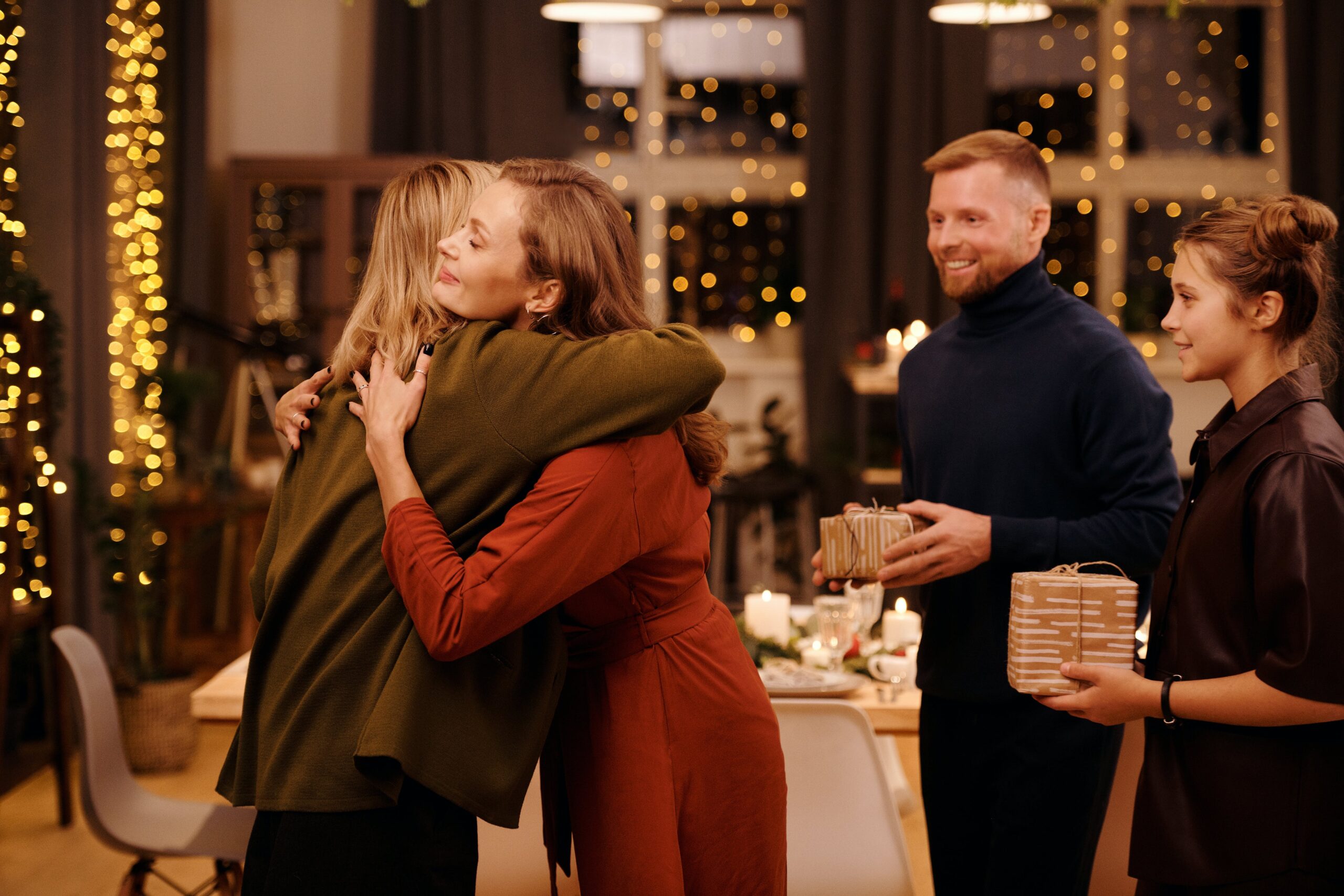 Family members embracing one another, depicting the issue of maintaining a sober Christmas celebration