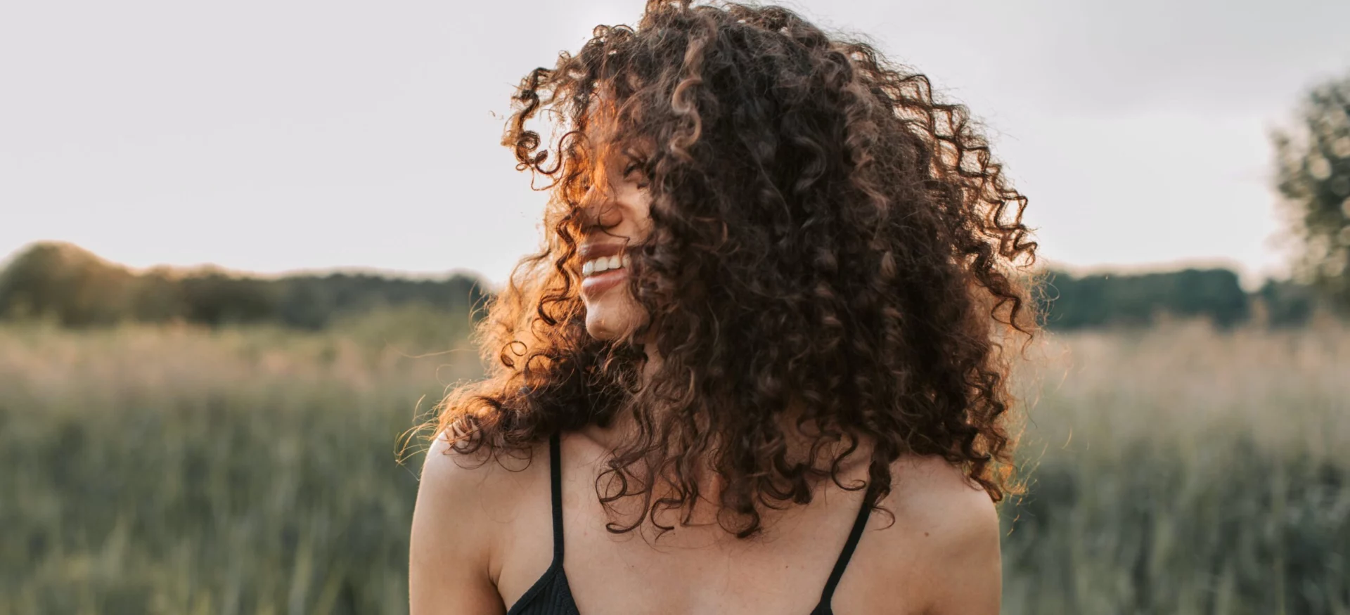 Woman walking through a grass field representing is prednisone addictive