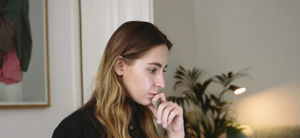 woman thinking representing how long does alcohol stay in your system