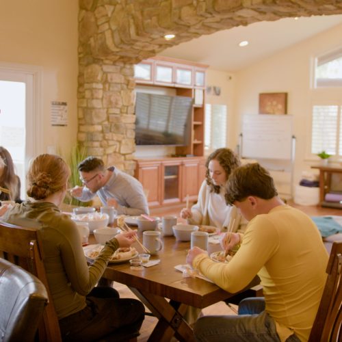 people have dinner together at gratitude lodge representing luxury rehab in California